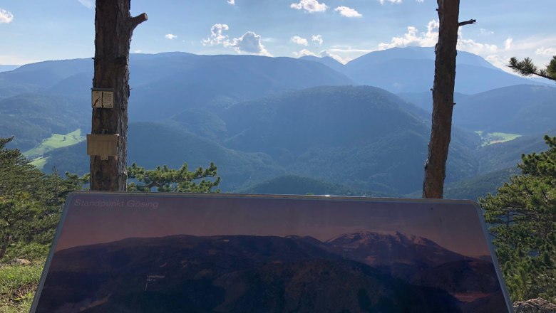 Gösing vantage point with a plaque and view of wooded mountains