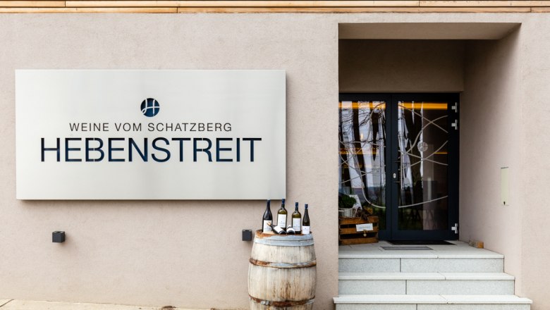 Entrance to Hebenstreit Weine with sign and wine barrel.