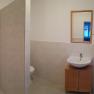 Bathroom with shower, washbasin and mirror.