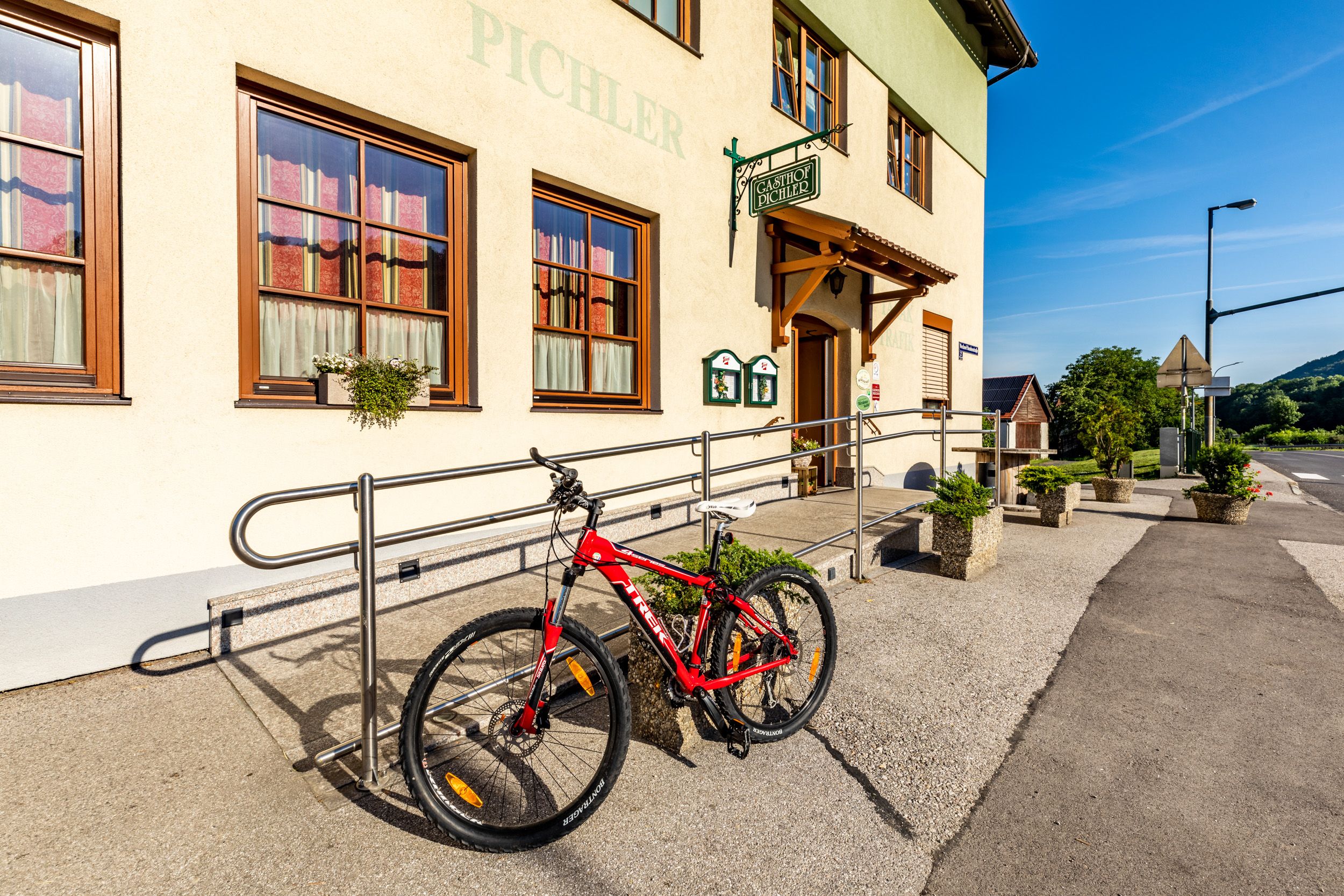 Bicycle in front of Gasthof Pichler on a sunny day.