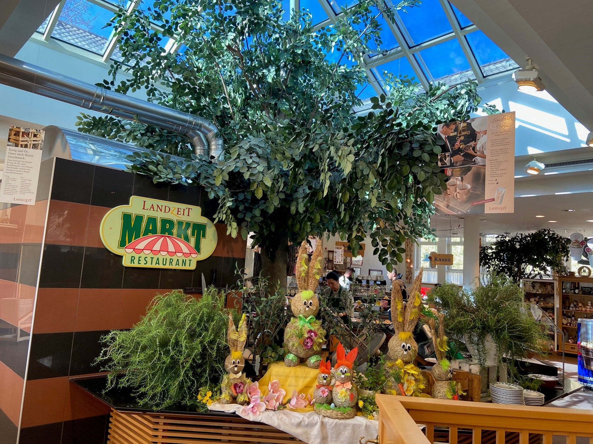 Interior view of a restaurant with decorations and plants.