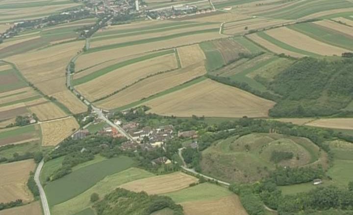 Aerial view of a rural landscape with fields and a small village.