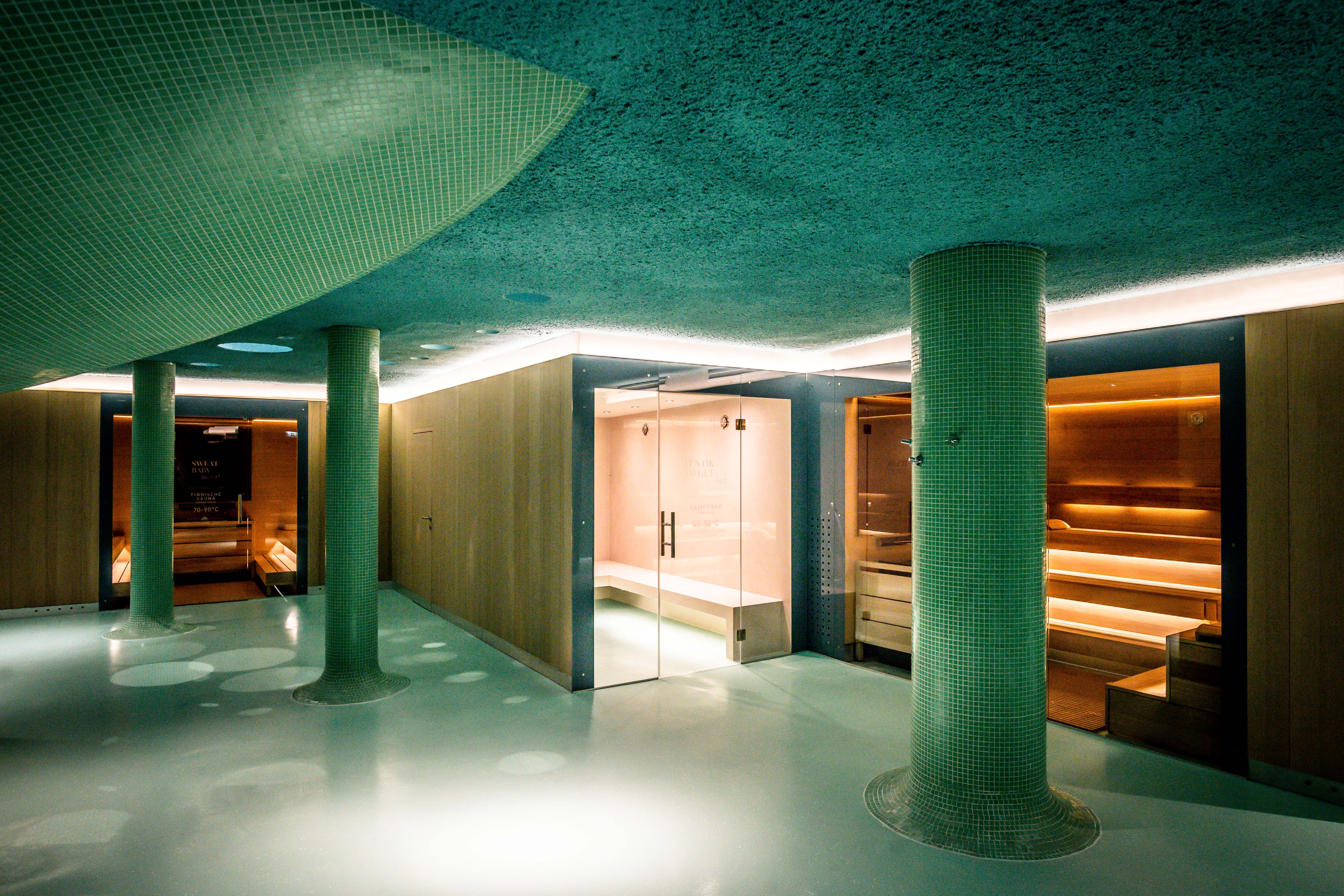 Modern building with pool and terrace in the foreground.