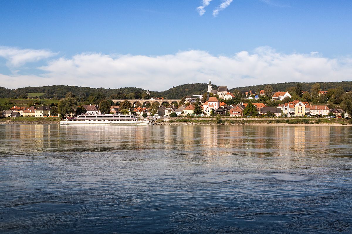 Panorama of the municipality of Emmersdorf an der Donau with a ship on the river.