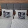 Double room with two single beds, gray headboard, gray pillows and white bed linen