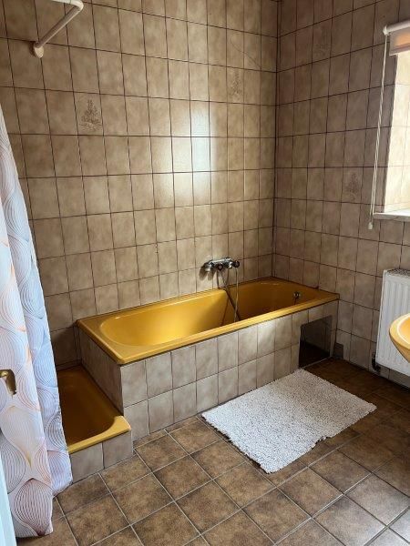 Bathroom with bathtub and shower