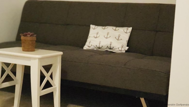 Gray sofa with white table.