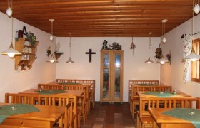Interior view of a rustic wine bar with wooden furniture and decorations.