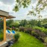 Garden with sun loungers and views of a green landscape.