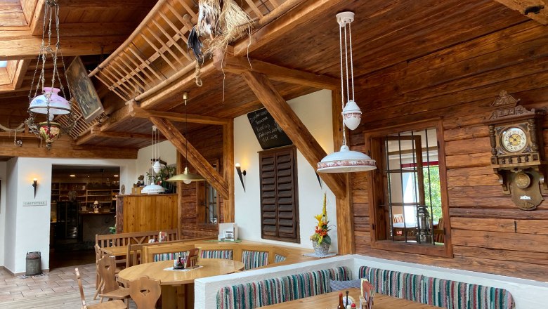 Rustic restaurant with wooden furniture and decorations.