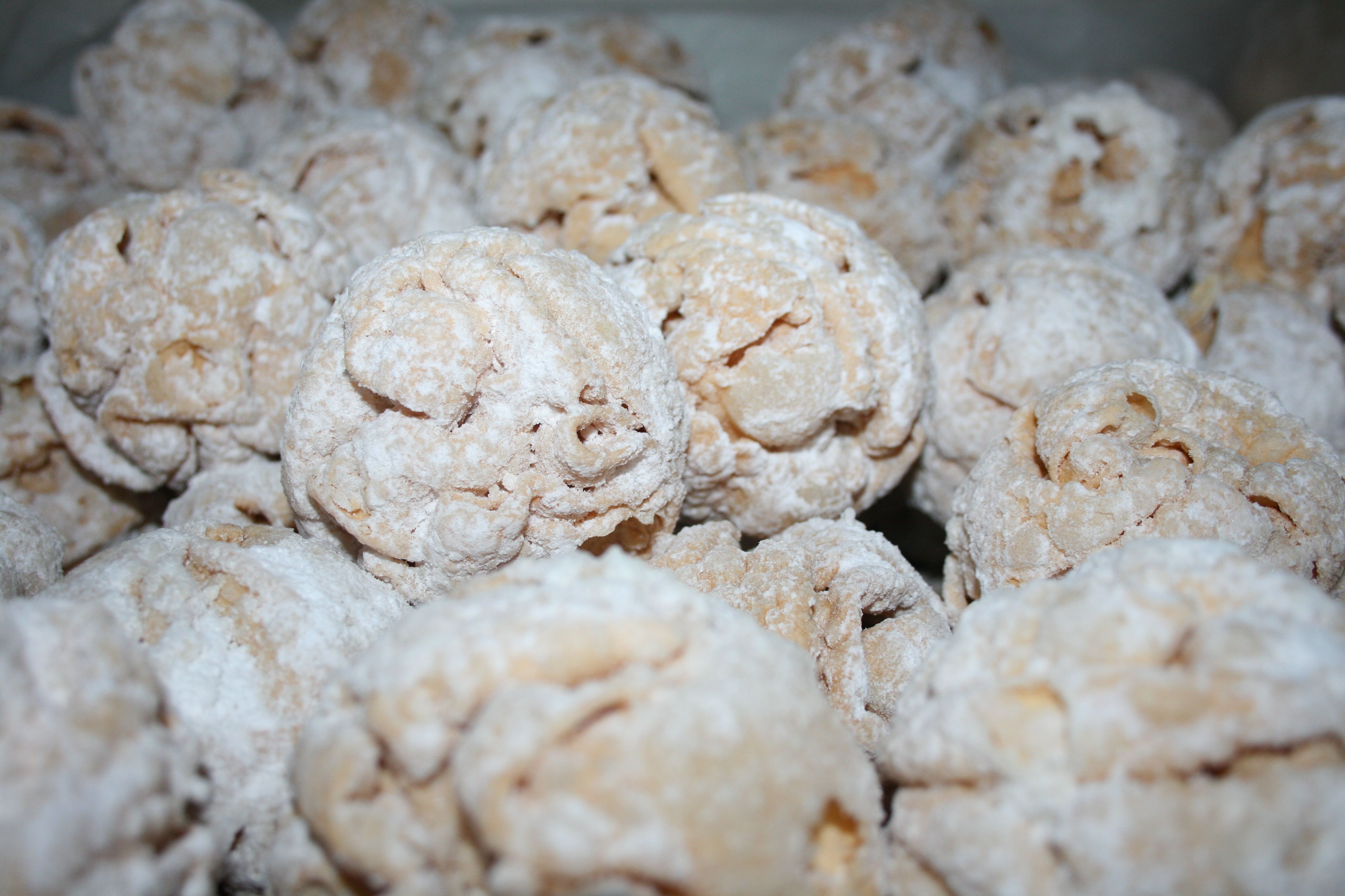 Close-up of pastry balls dusted with powdered sugar.