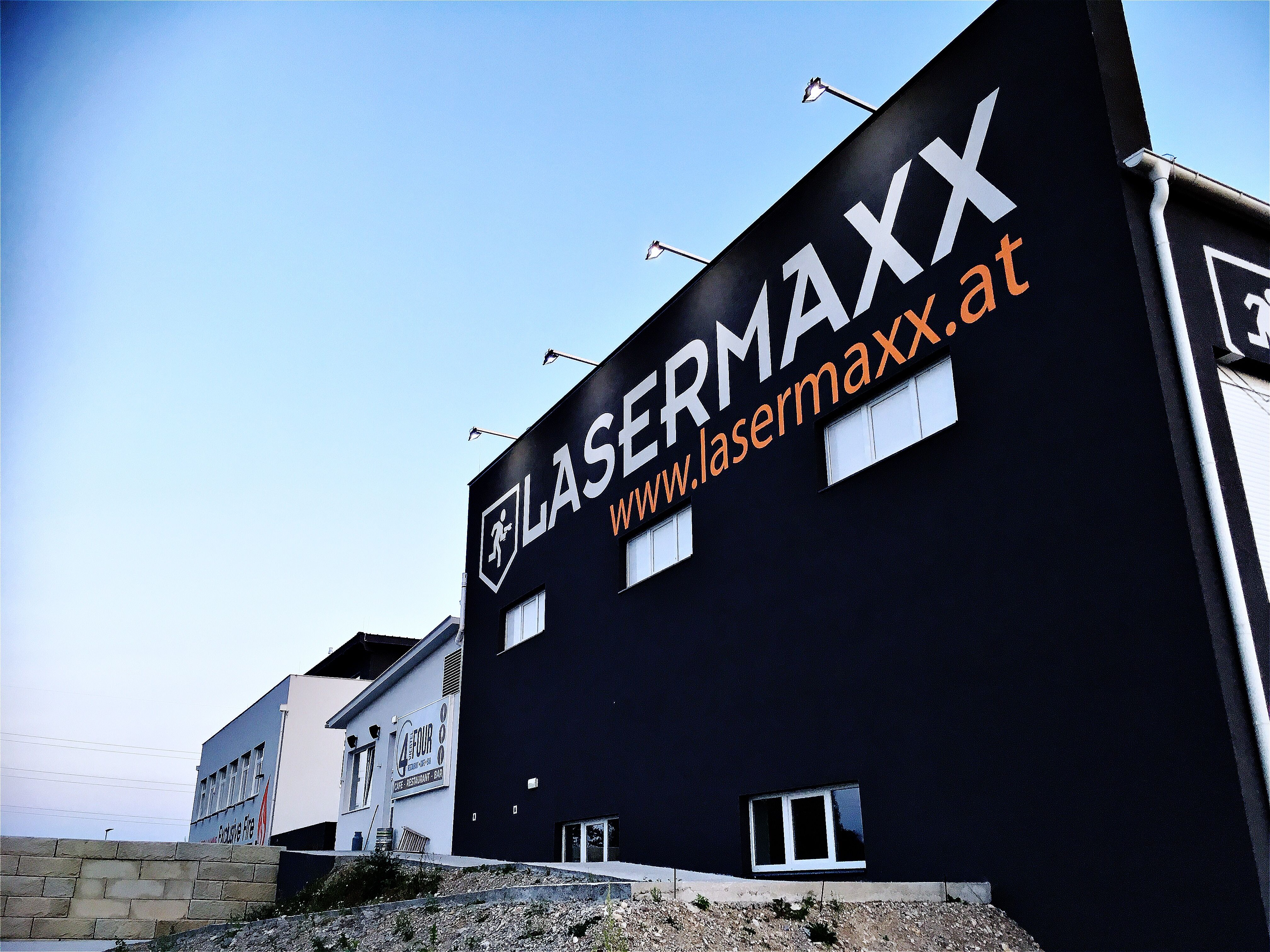 Building with large Lasermaxx logo and website address on the façade.