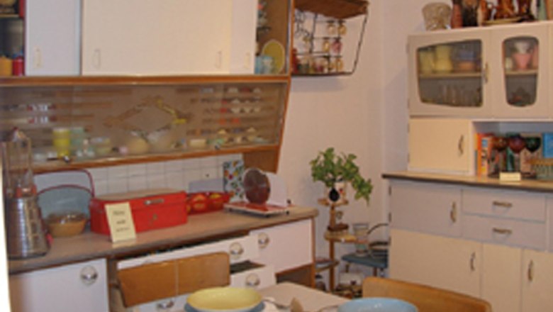 Interior view of a kitchen museum with retro furniture and crockery.