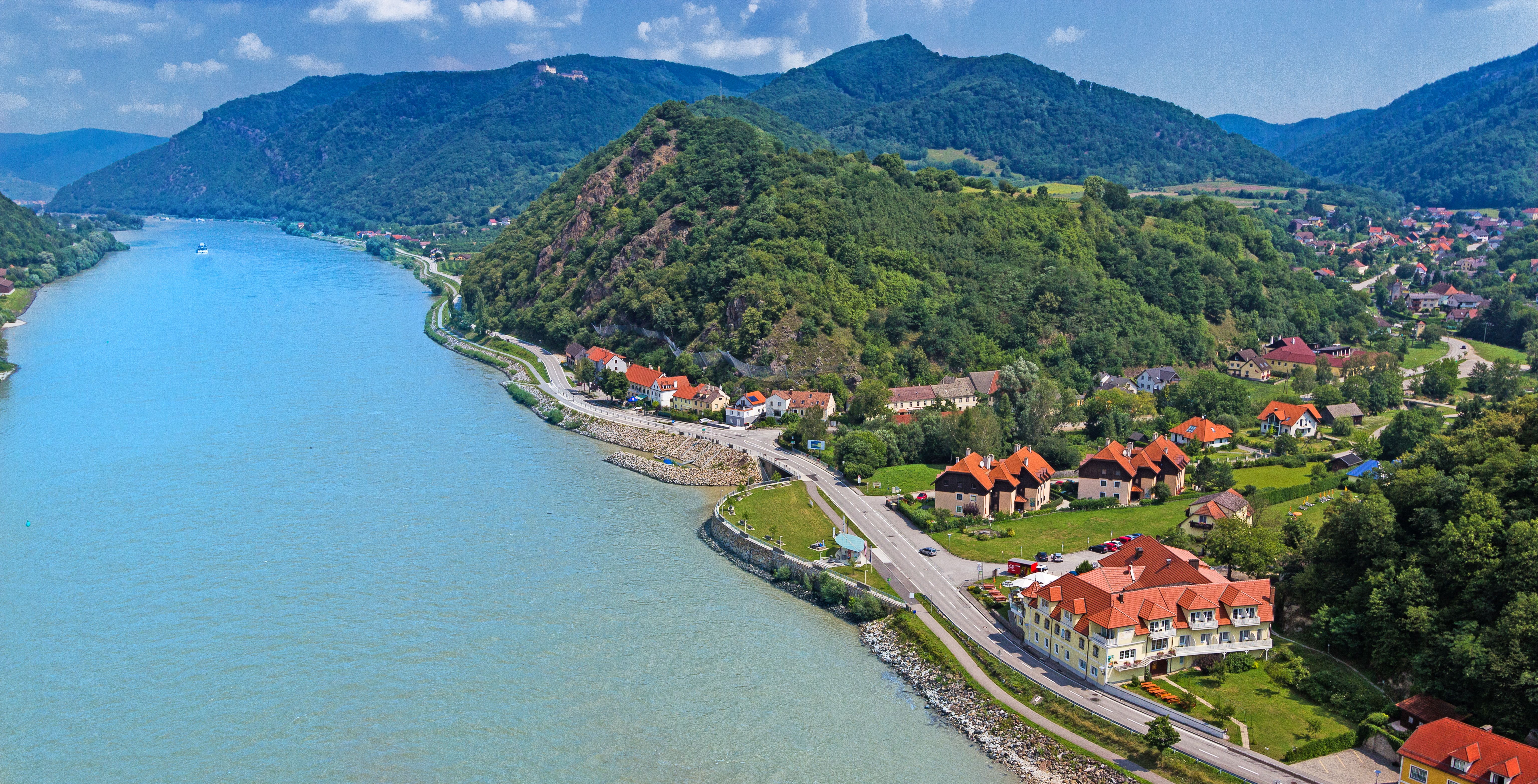 Aerial view of the Wachau with the Danube, hills and buildings.