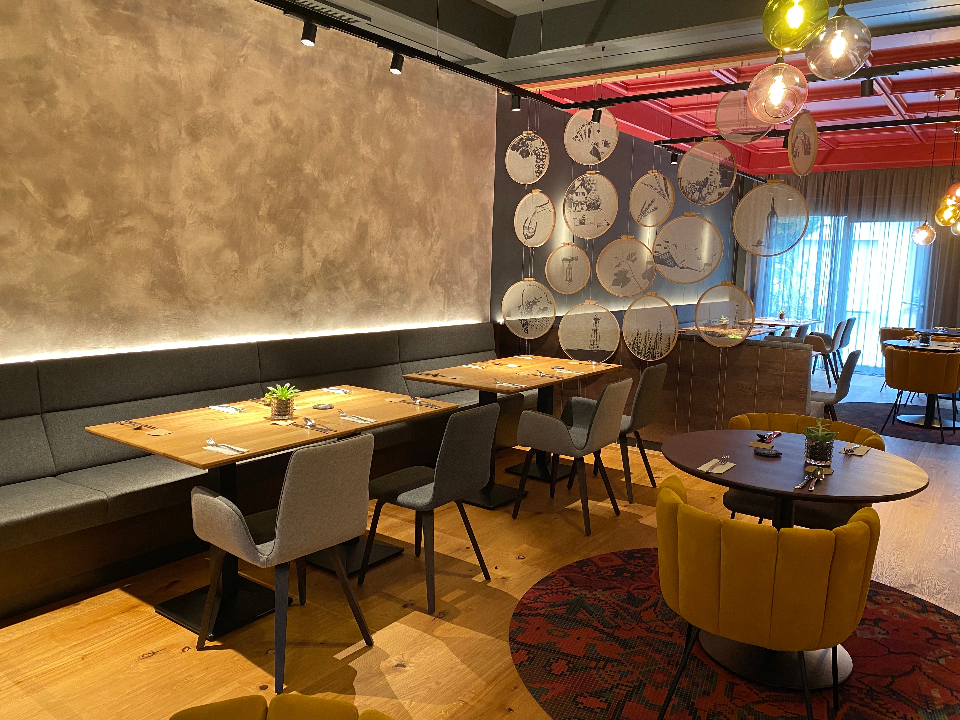 Modern restaurant with stylish furnishings and decorative elements on the wall.