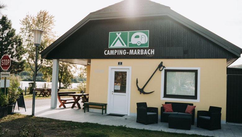 Entrance area of the Marbach campsite with seating and an anchor on the wall.