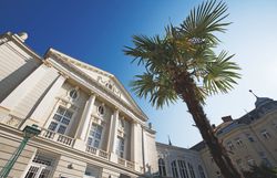 The Stadttheater Baden at night, illuminated with warm light.