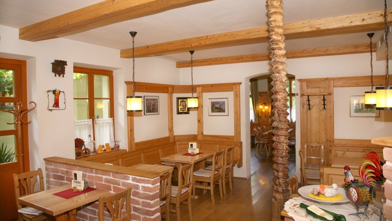 Cozy dining room with wooden furniture and decorations.