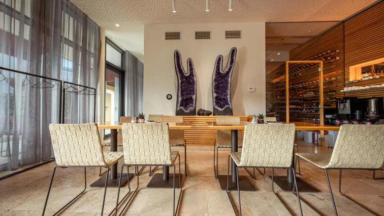 Interior view of a modern dining area with large amethysts on the wall.