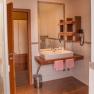 Modern bathroom with washbasin, mirror, towels and hairdryer.
