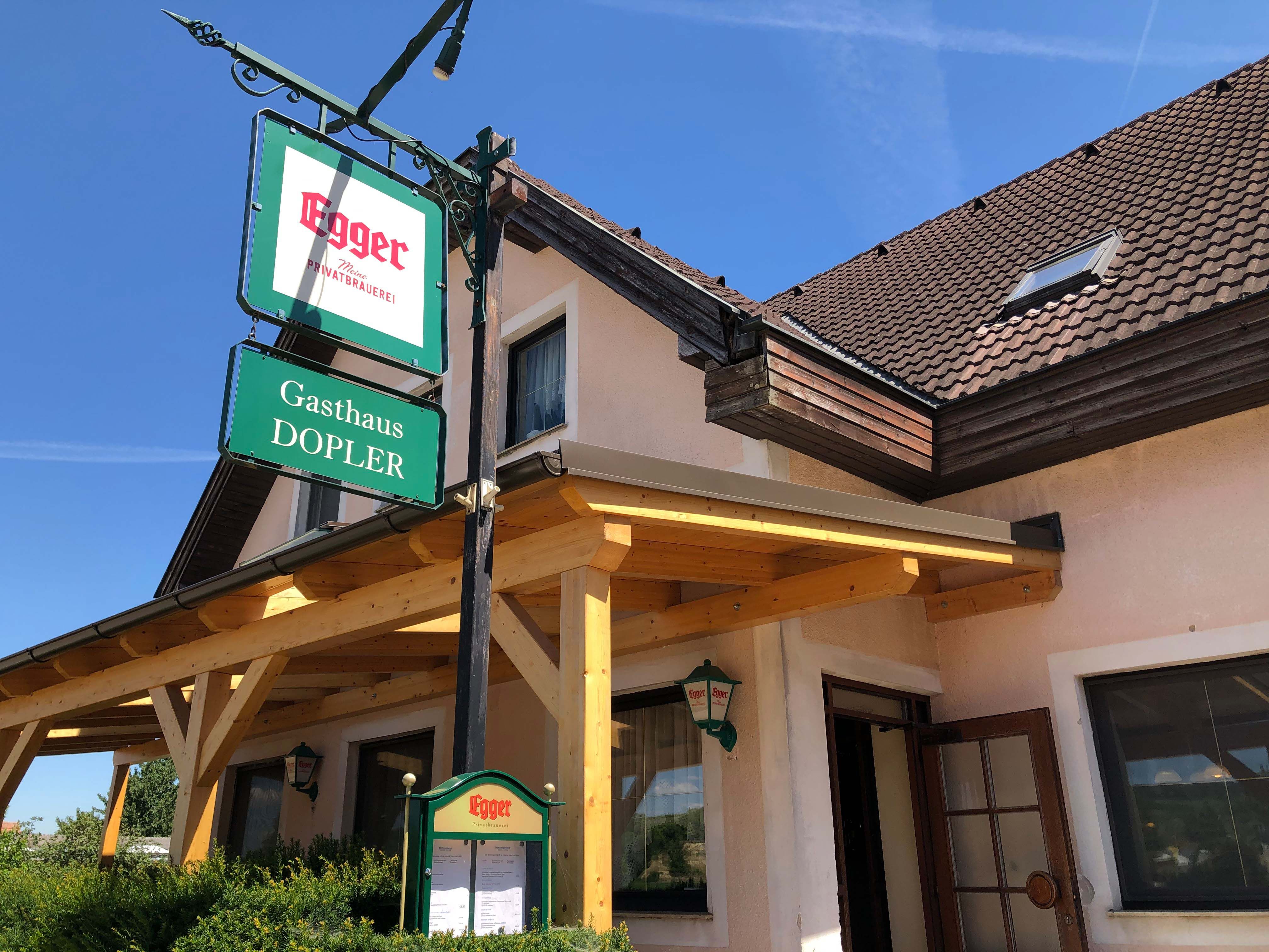 Gasthaus Doppler with Egger brewery sign and wooden roof.