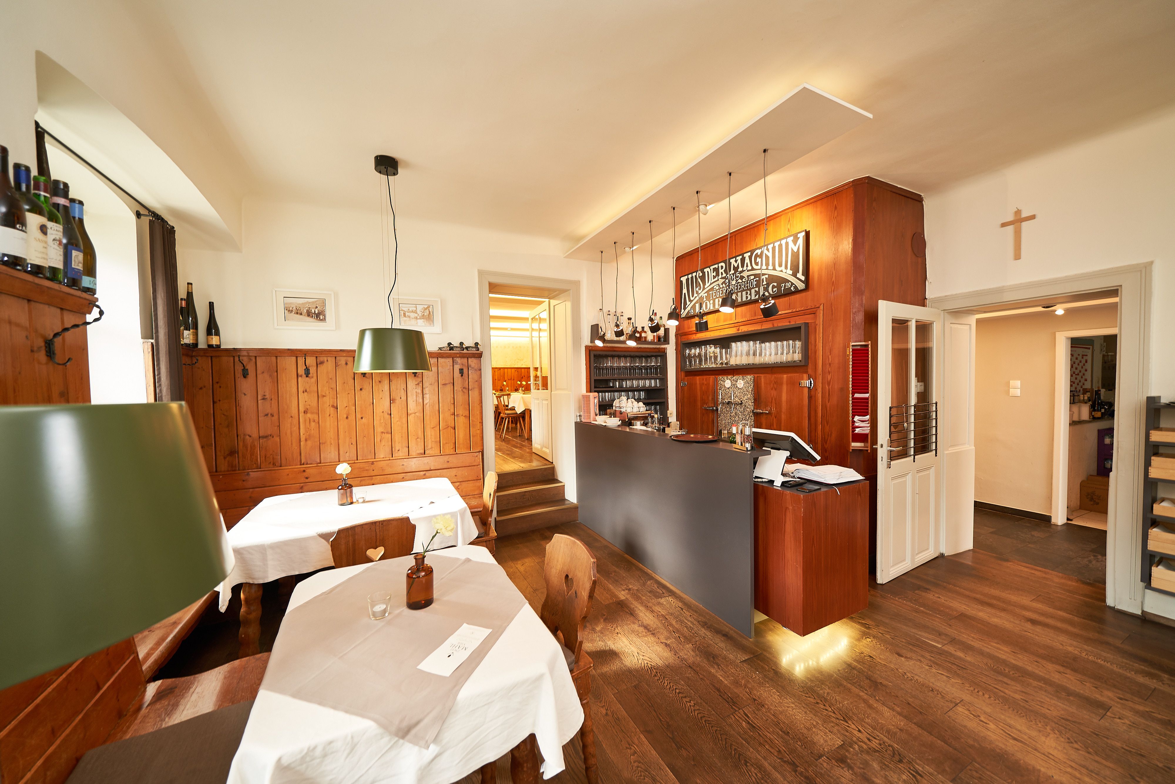 Interior view of a cozy dining room with wooden furniture and bar.