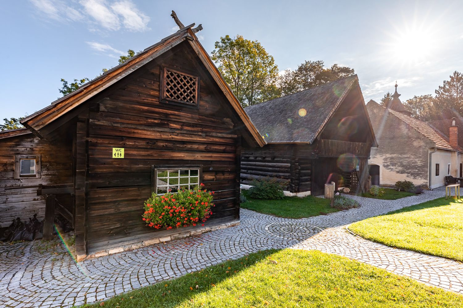 Traditional wooden houses in the Krumbach museum village in the sunshine.