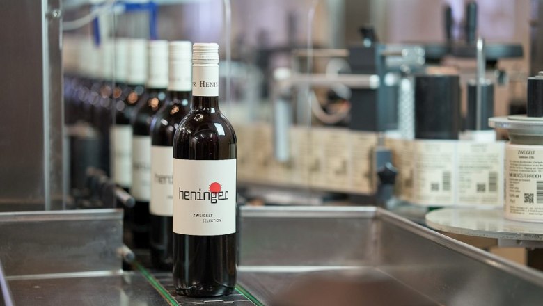 Wine bottles on a conveyor belt in a bottling plant.