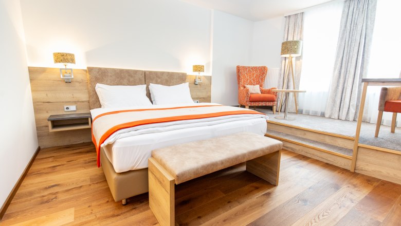 A modern double room with an extra reading and writing corner.