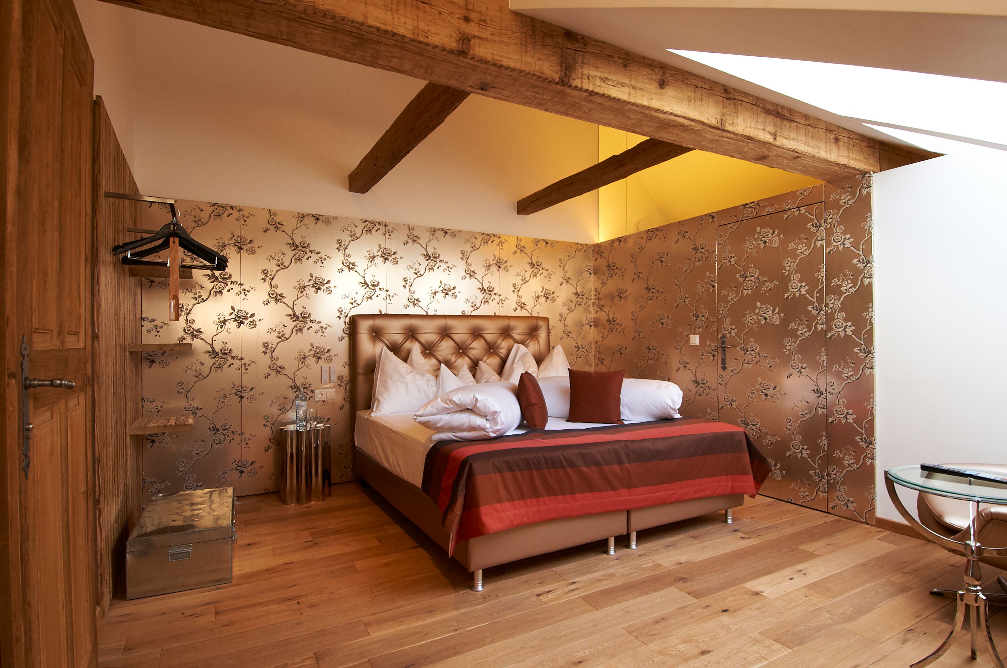 Garden with pool, sun loungers and parasols at Hotel Landhaus Moserhof.