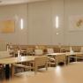 Interior view of a modern restaurant with wooden furniture and minimalist decoration.