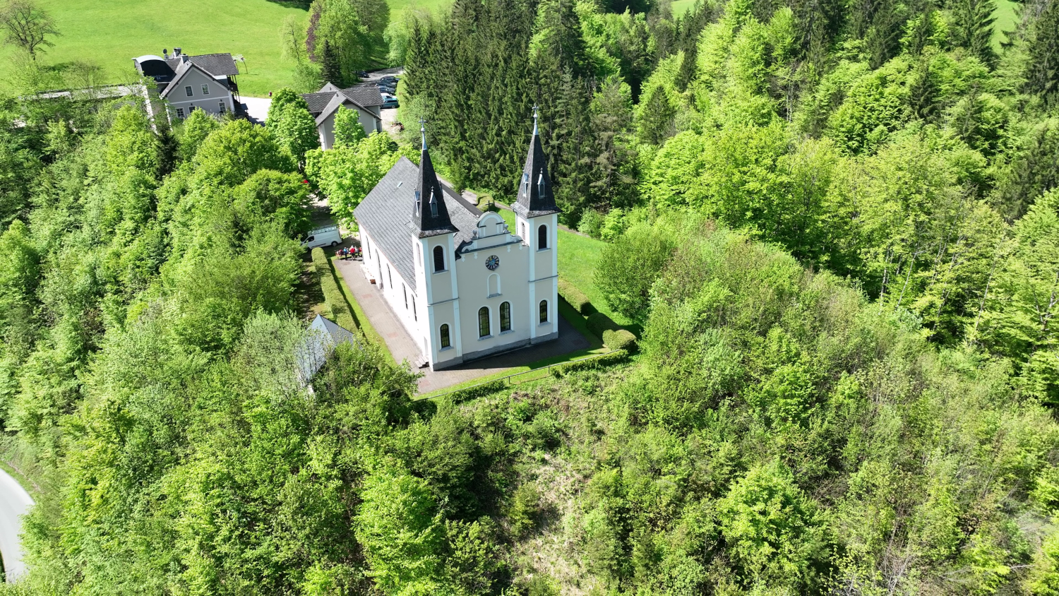 Aerial view of the Maria Seesal pilgrimage church, surrounded by green trees and forests.