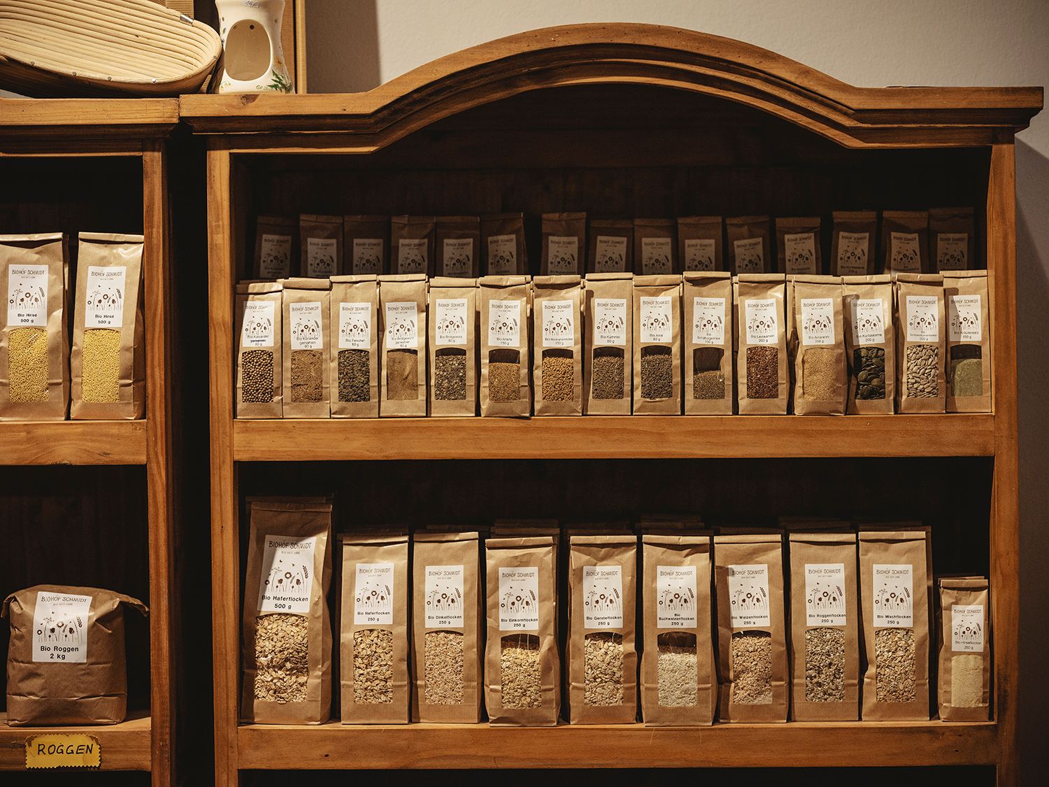 Shelf with various cereal and seed packets in a store.