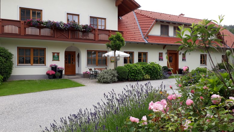 Exterior view of a house with flowers and garden.