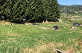 3D archery course with targets and forest in the background.