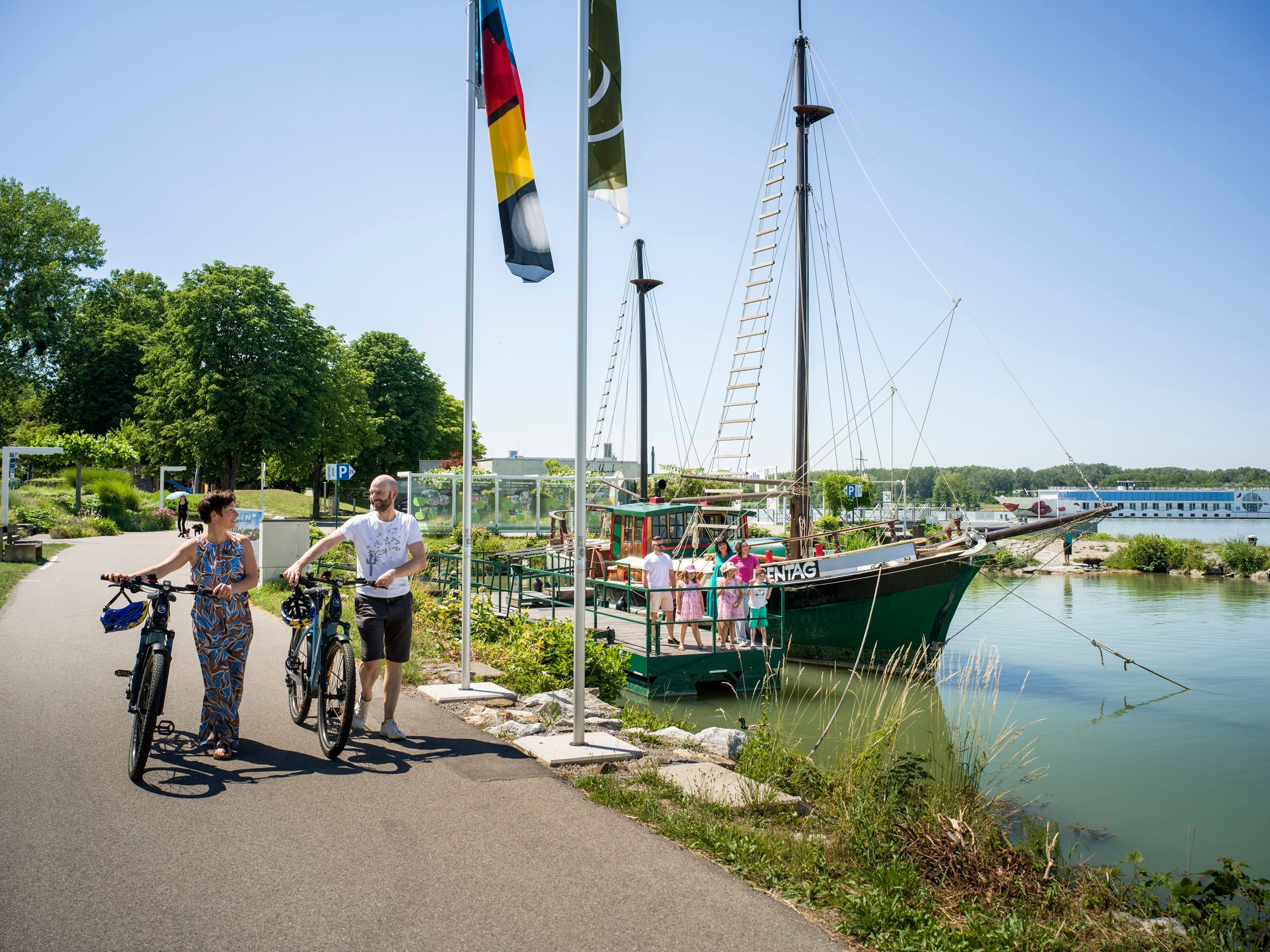 historic ship in the water with cyclists on the Danube cycle path 