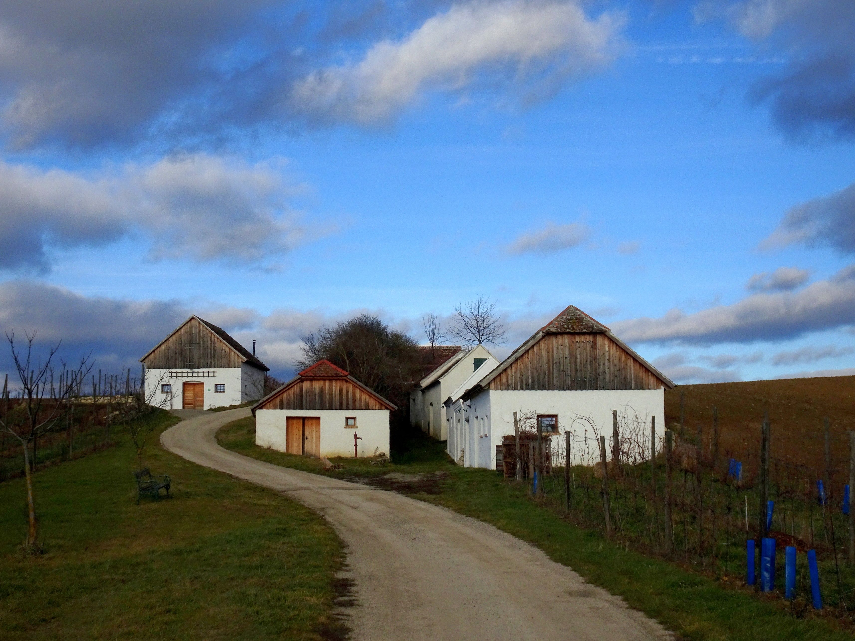 Wine cellar in a rural landscape with blue sky and clouds.