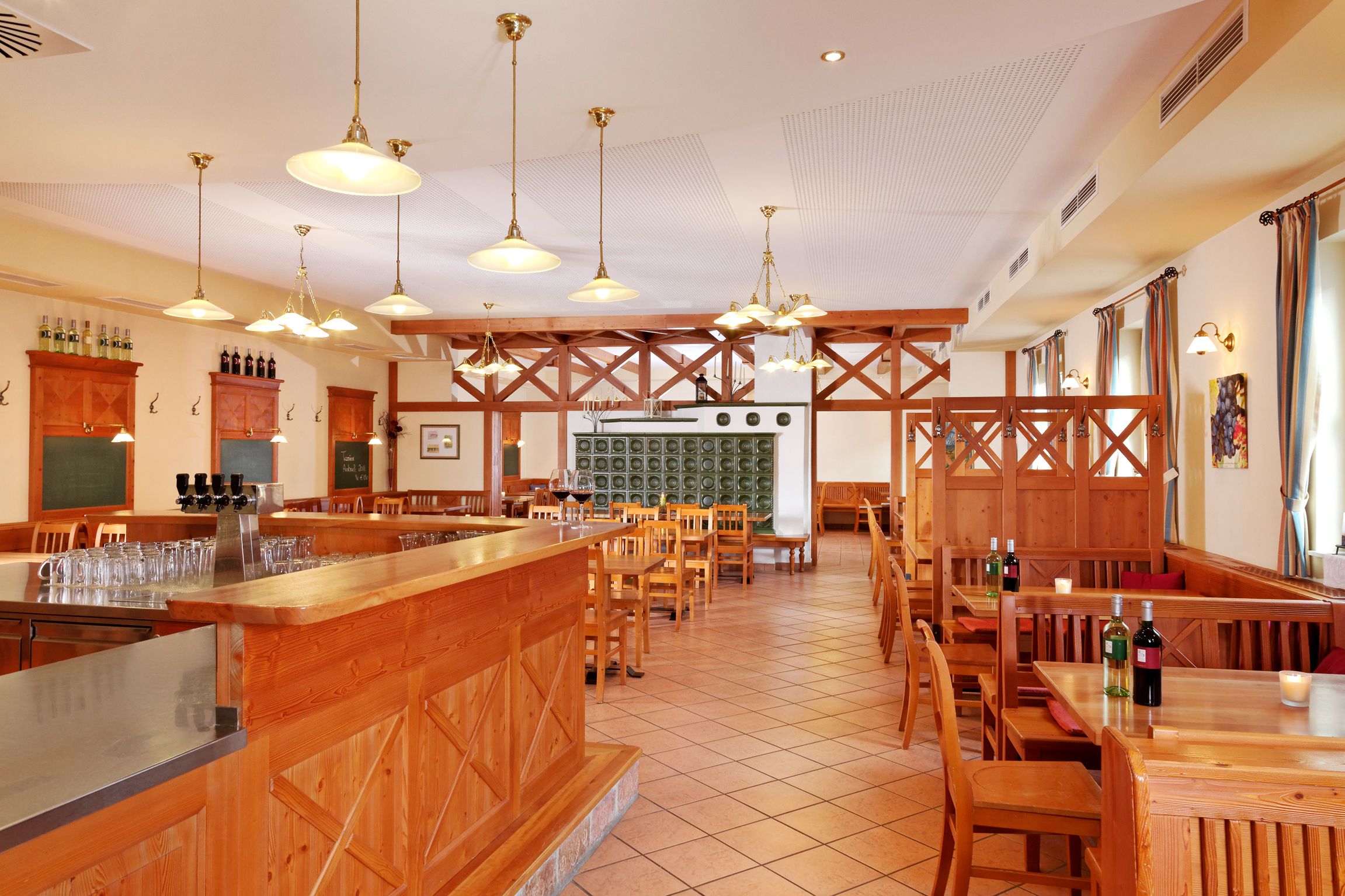 Interior view of a wine tavern with wooden furniture and tiled floor.