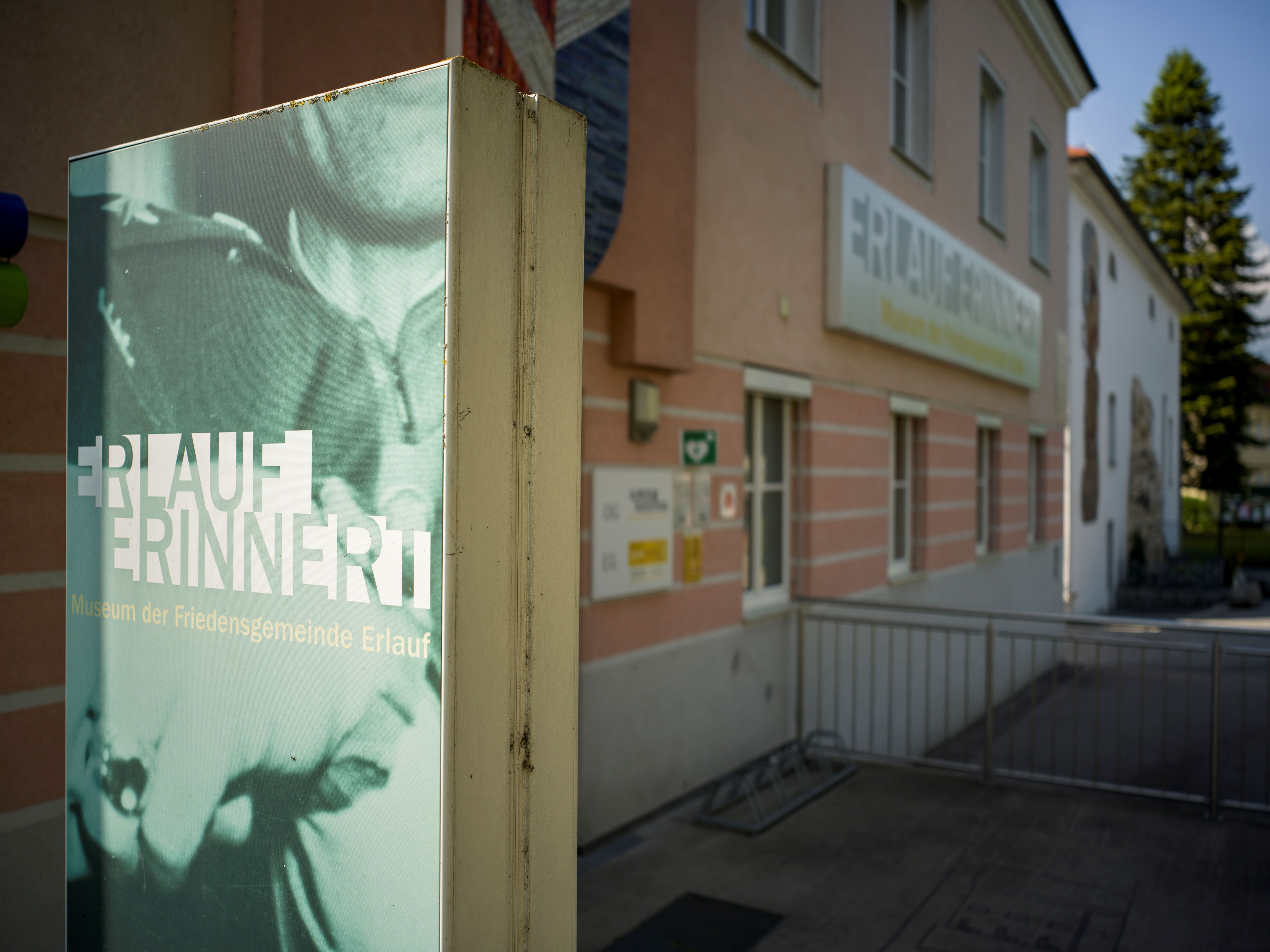 Exterior view of the Erlauf Peace Museum with sign 'Erlauf remembers'.