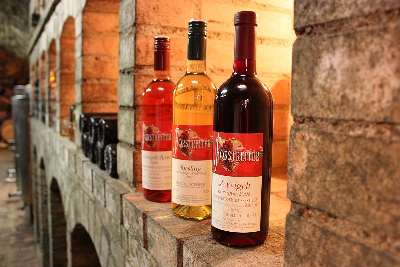 Three bottles of wine on a shelf in the wine cellar.