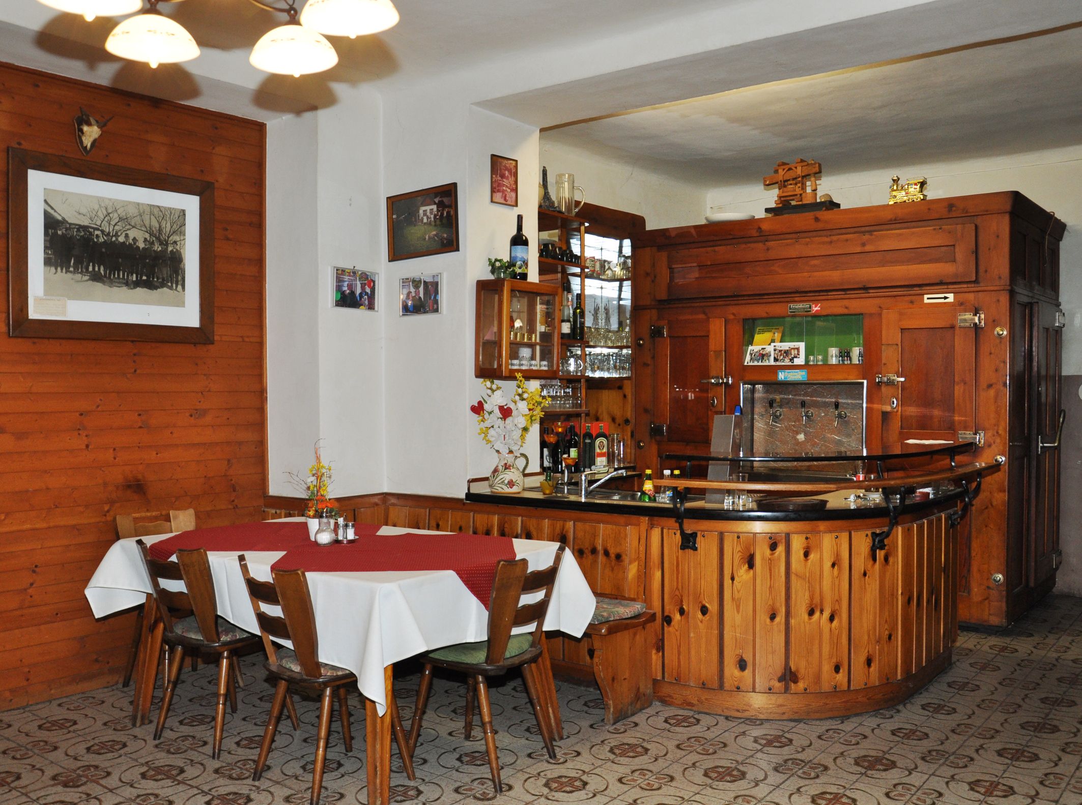 Interior view of a traditional inn with wooden furniture and bar.