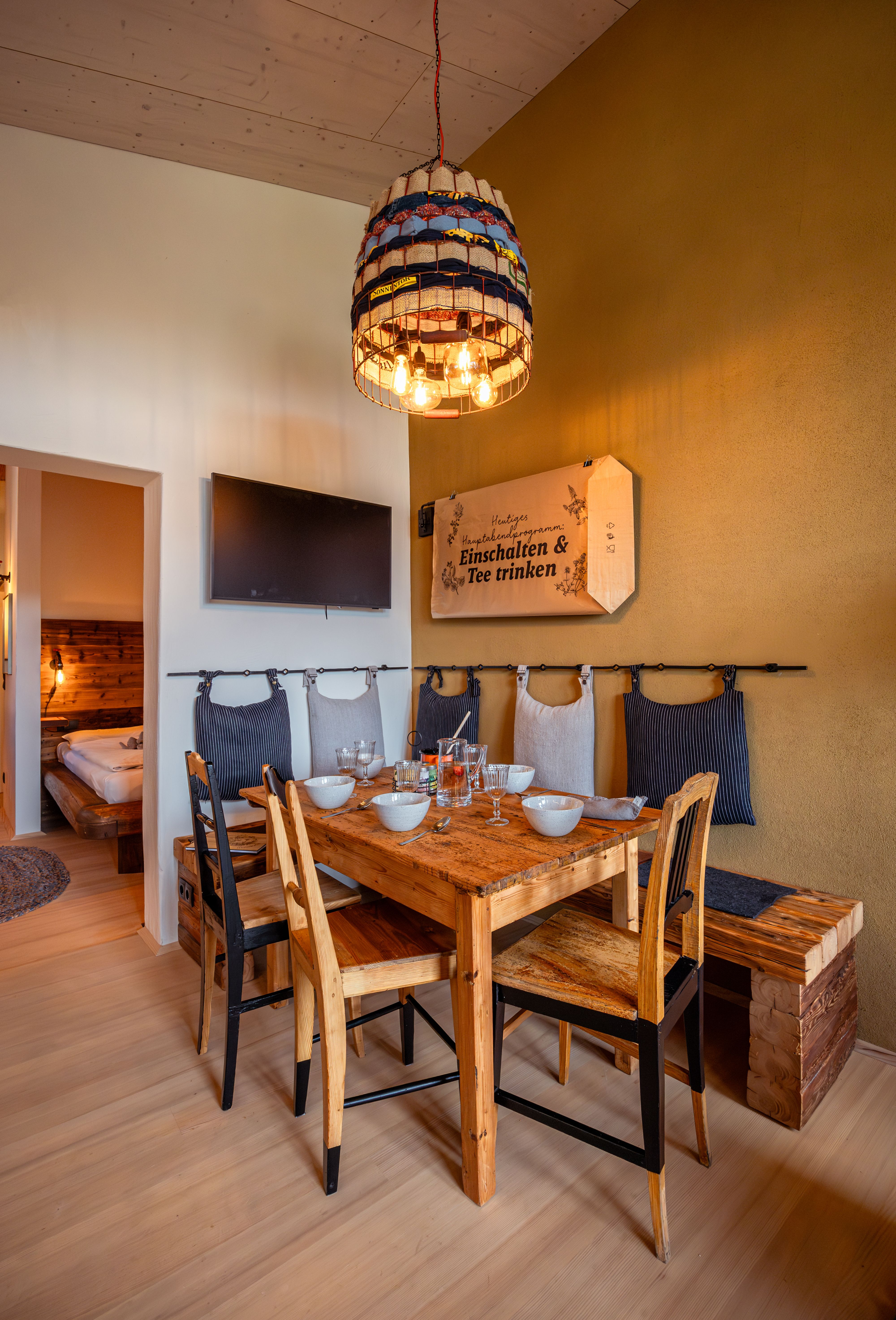Inner courtyard with paved path, plants and modern buildings under a blue sky.