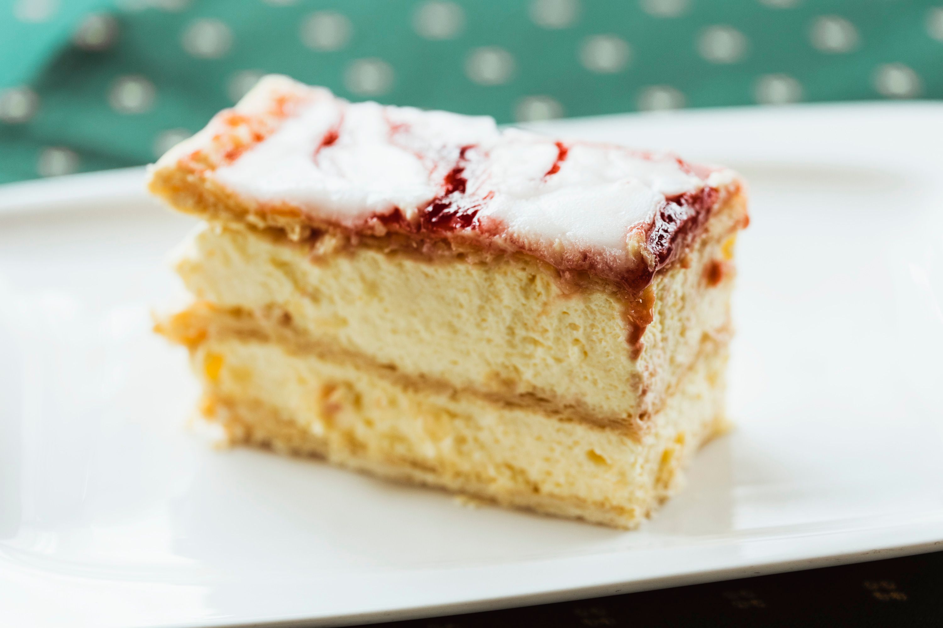 A slice of cream slice on a white plate.