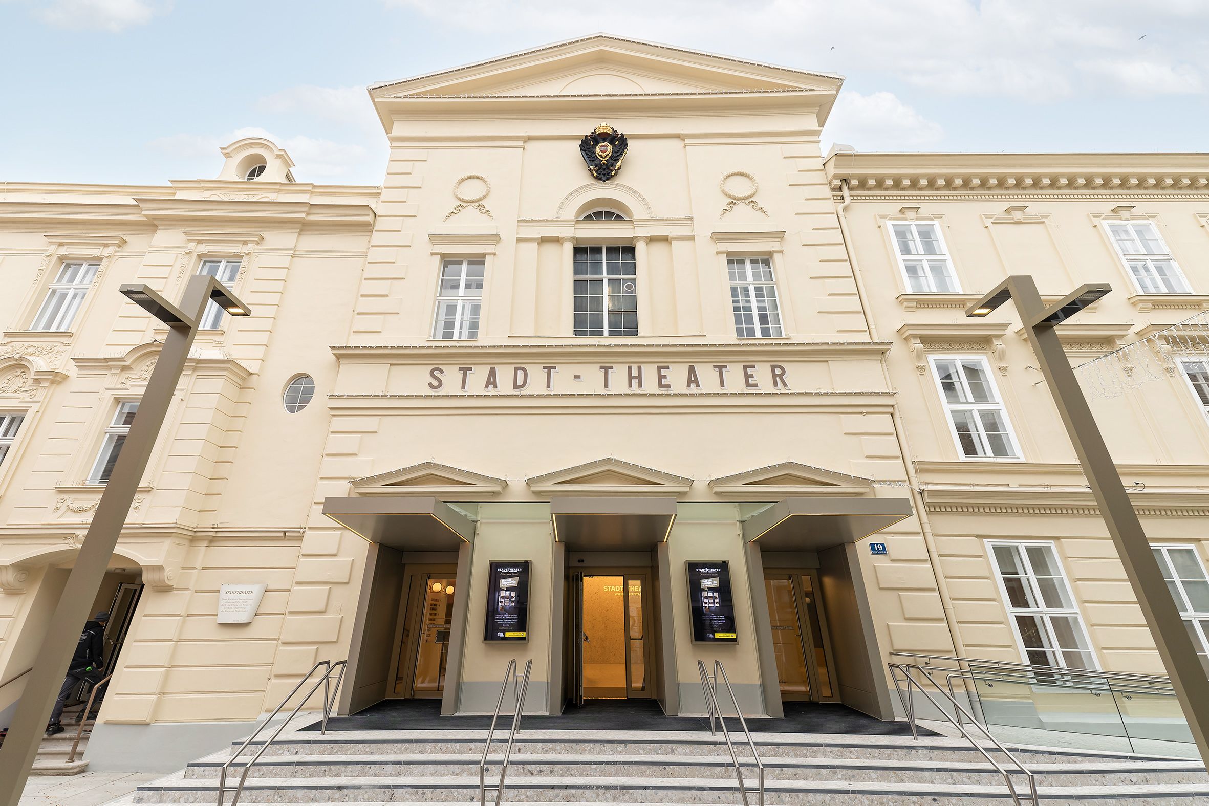 Interior view of the magnificent Wiener Neustadt City Theater with golden yellow velvet armchairs, boxes and sparkling chandelier