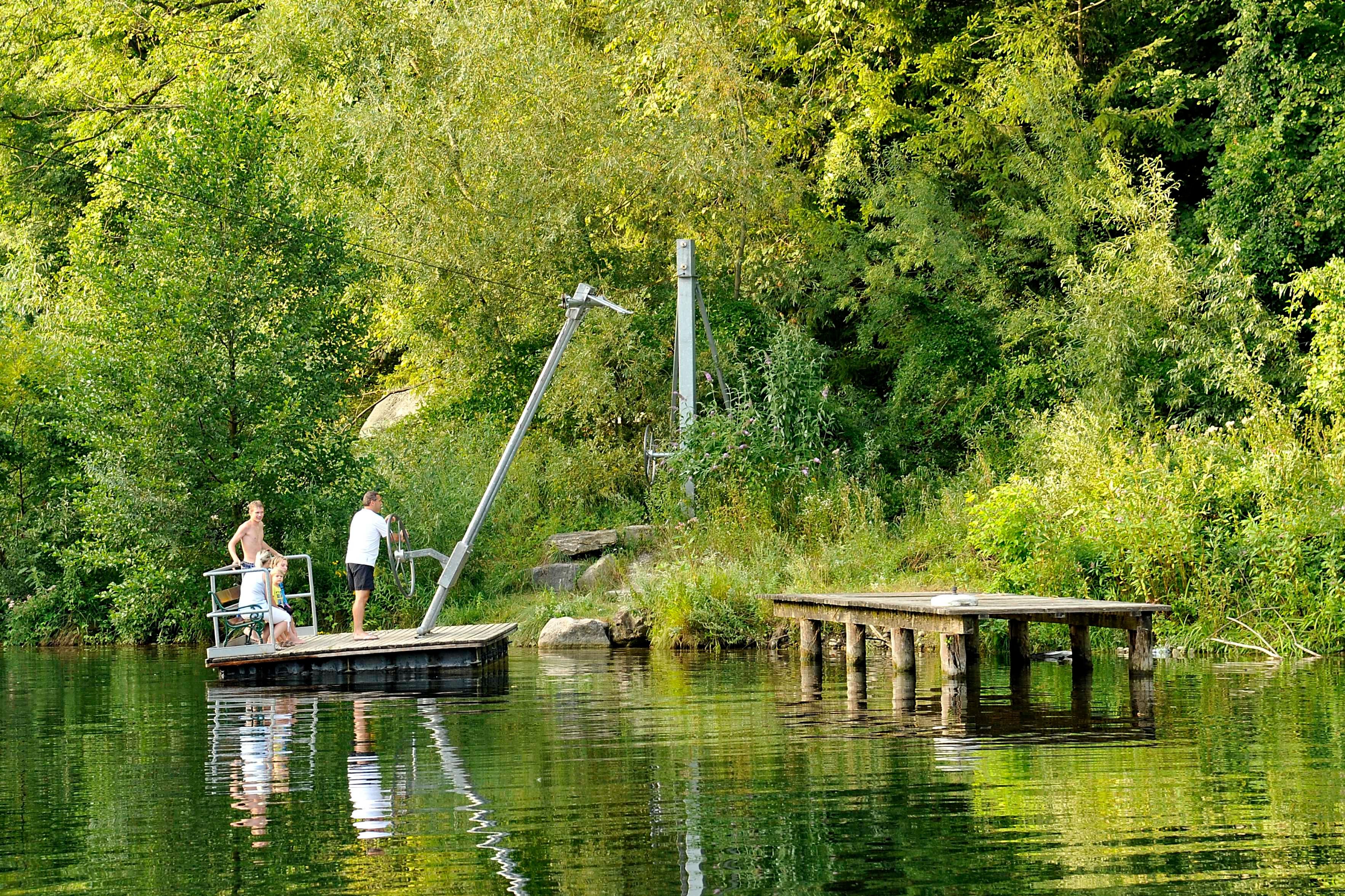 People on a platform in the Kematen natural pool.