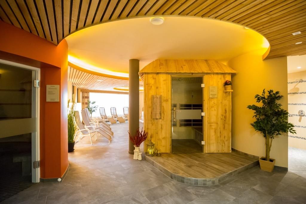 Interior view of a sauna area with wooden sauna and loungers.