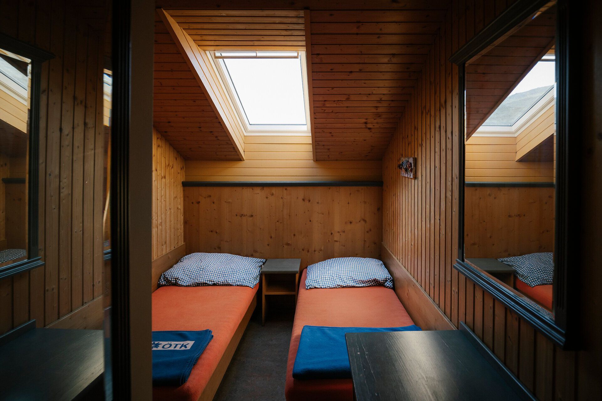 Twin room with a skylight and wood paneling at the Damböckhaus on Schneeberg