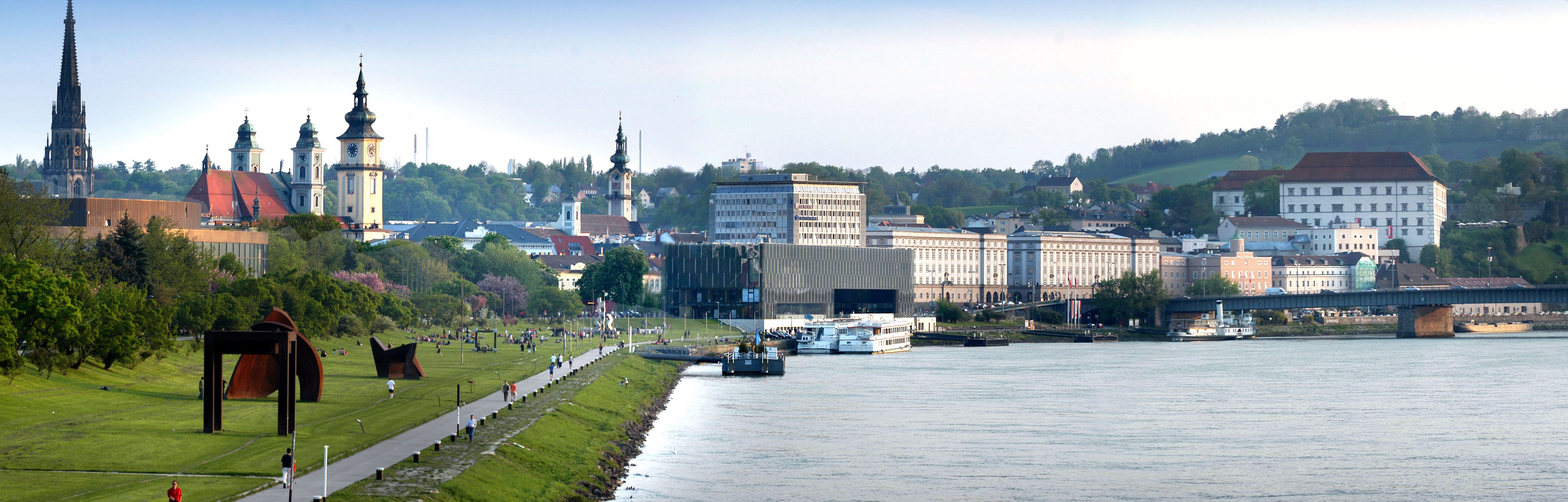 Panorama of Linz with the Danube, churches and modern architecture.