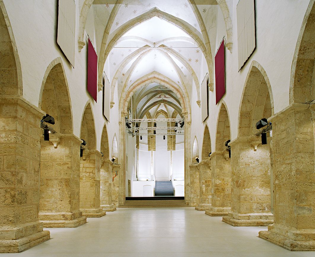 Interior view of the Minorite Church in Krems with Gothic arches and modern lighting.