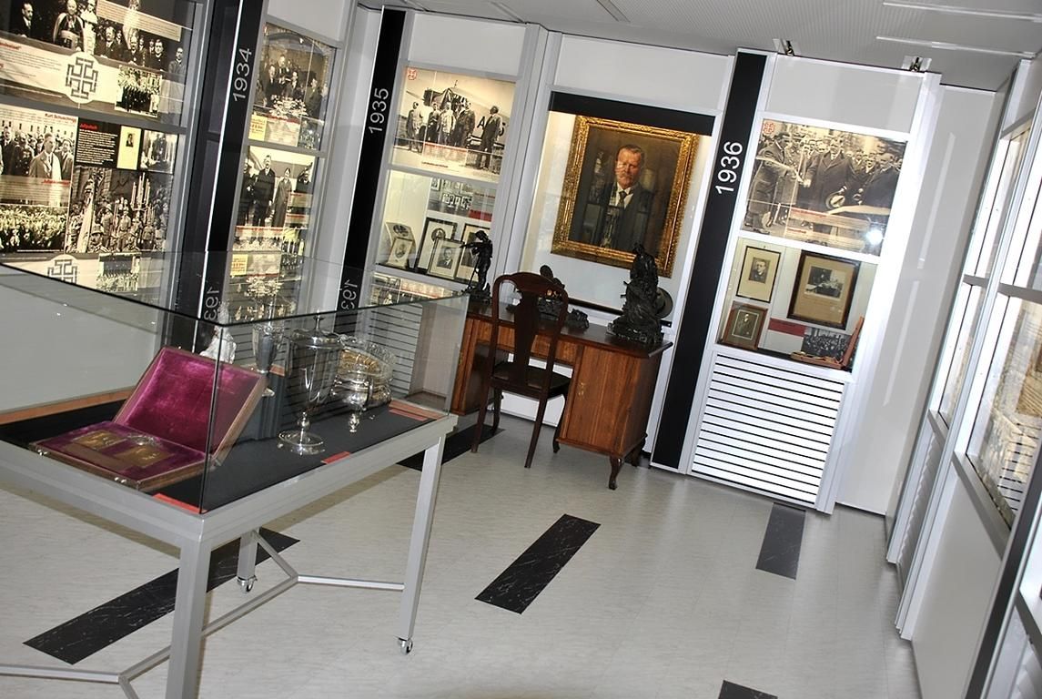 Interior view of a museum with historical exhibits and photos.